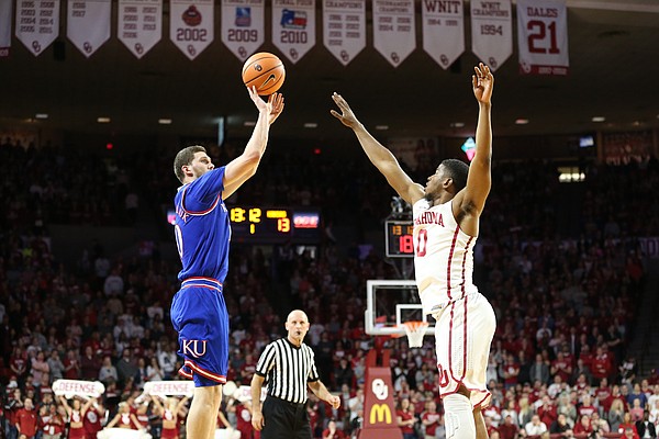 Kansas guard Sviatoslav Mykhailiuk (10) pulls up for a three in front of Oklahoma guard Christian James (0) during the first half at Lloyd Noble Center on Tuesday, Jan. 23, 2018 in Norman, Oklahoma.