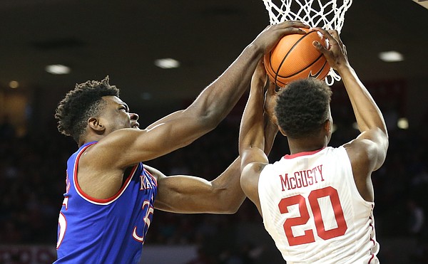 Kansas center Udoka Azubuike (35) battles for a ball with Oklahoma guard Kameron McGusty (20) during the first half at Lloyd Noble Center on Tuesday, Jan. 23, 2018 in Norman, Oklahoma.