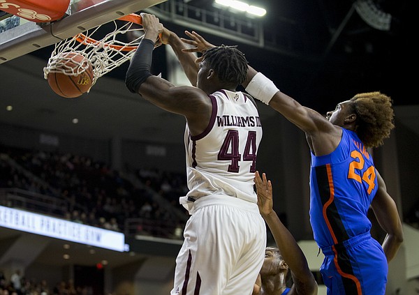 Texas A&M forward Robert Williams (44) dunks the ball as Florida guard Deaundrae Ballard (24) defends during the first half of an NCAA college basketball game Tuesday, Jan. 2, 2018, in College Station, Texas.