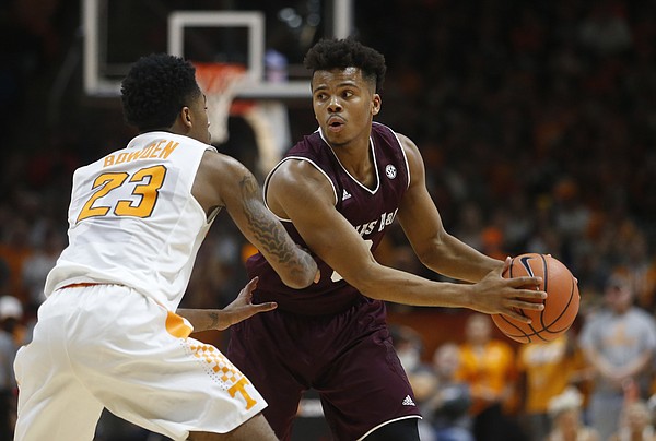 Texas A&M guard Admon Gilder (3) is defended by Tennessee guard Jordan Bowden (23) during the second half of an NCAA college basketball game Saturday, Jan. 13, 2018, in Knoxville, Tenn.