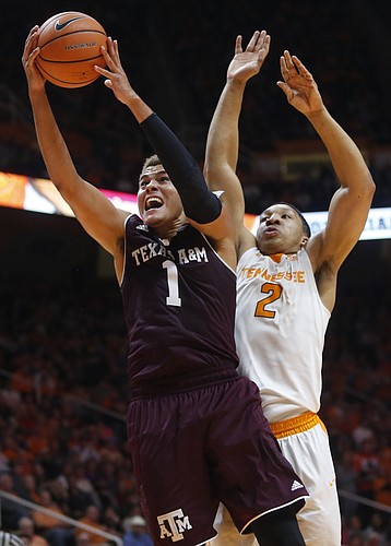Texas A&M forward DJ Hogg (1) is defended under the basket by Tennessee forward Grant Williams (2) during the second half of an NCAA college basketball game Saturday, Jan. 13, 2018, in Knoxville, Tenn. 