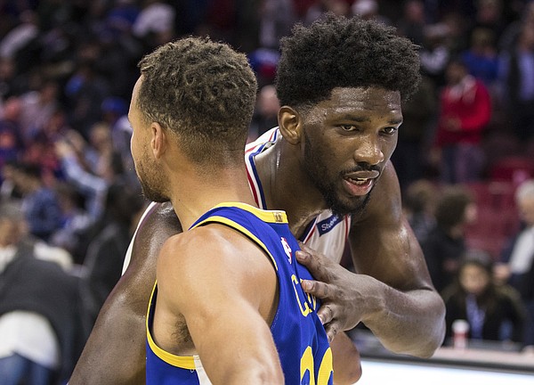 Philadelphia 76ers' Joel Embiid, of Cameroon, right, gives Golden State Warriors' Stephen Curry, left, a hug following the second half of an NBA basketball game, Saturday, Nov. 18, 2017, in Philadelphia. The Warriors won 124-116. (AP Photo/Chris Szagola)