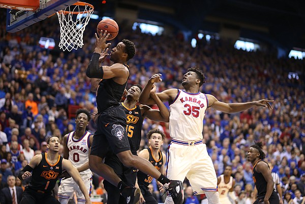 Kansas center Udoka Azubuike (35) watches as Oklahoma State forward Cameron McGriff (12) pulls down a rebound during the first half, Saturday, Feb. 3, 2018 at Allen Fieldhouse.