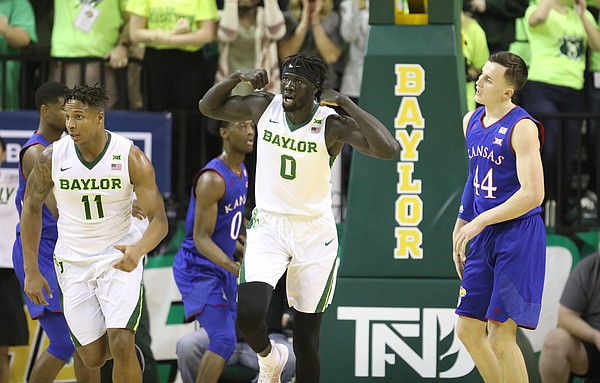 Baylor Bears forward Jo Lual-Acuil Jr. (0) flexes next to Kansas forward Mitch Lightfoot (44) after a bucket during the first half, Saturday, Feb. 11, 2018 at Ferrell Center in Waco, Texas.