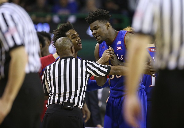 Kansas center Udoka Azubuike (35) is sent back to the bench by an official and his teammate Kansas guard Devonte' Graham (4) while protesting a call during the second half, Saturday, Feb. 11, 2018 at Ferrell Center in Waco, Texas.