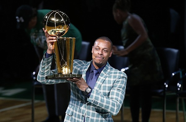 Former Boston Celtics Paul Pierce holds the NBA championship trophy that he won with the team during a ceremony to retire his number following a basketball game against the Cleveland Cavaliers in Boston, Sunday, Feb. 11, 2018. (AP Photo/Michael Dwyer)