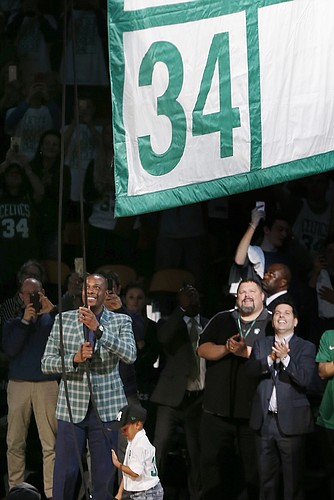 Former Boston Celtics Paul Pierce, left, raises a banner during a ceremony to retire his number following an NBA basketball game against the Cleveland Cavaliers in Boston, Sunday, Feb. 11, 2018. (AP Photo/Michael Dwyer)