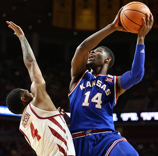 Kansas guard Malik Newman (14) puts up a shot after a foul from Iowa State guard Donovan Jackson (4) during the first half, Tuesday, Feb. 13, 2018 at Hilton Coliseum in Ames, Iowa.