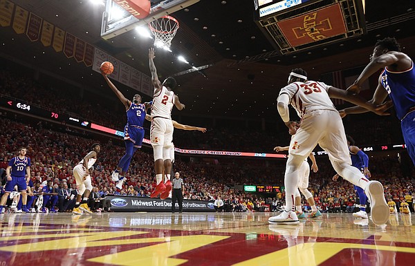 Kansas guard Lagerald Vick (2) swoops in for a bucket against Iowa State forward Cameron Lard (2) during the second half, Tuesday, Feb. 13, 2018 at Hilton Coliseum in Ames, Iowa.