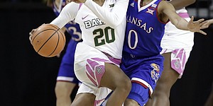 Baylor guard Juicy Landrum (20) works against Kansas guard Christalah Lyons (0) in the first half of an NCAA college basketball game Saturday, Feb. 17, 2018, in Waco, Texas. (AP Photo/Tony Gutierrez)