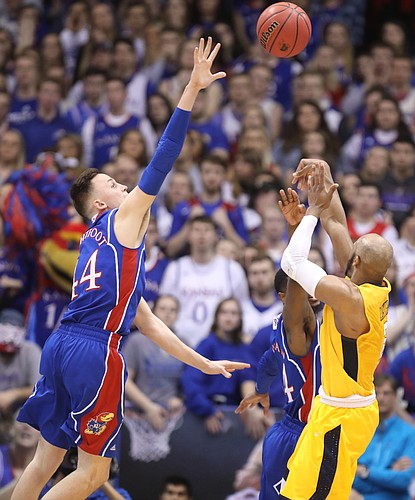 Kansas forward Mitch Lightfoot (44) defends against a shot from West Virginia guard Jevon Carter (2) during the first half, Saturday, Feb. 17, 2018 at Allen Fieldhouse.