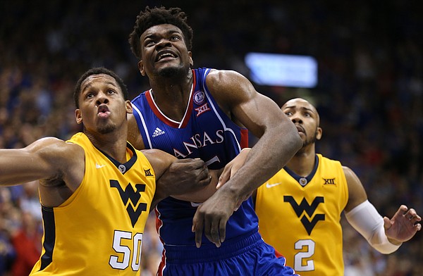 Kansas center Udoka Azubuike (35) fights for position with West Virginia forward Sagaba Konate (50) and West Virginia guard Jevon Carter (2) during the second half, Saturday, Feb. 17, 2018 at Allen Fieldhouse.