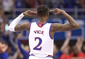 Kansas guard Lagerald Vick (2) celebrates a three during the first half, Monday, Feb. 19, 2018 at Allen Fieldhouse.