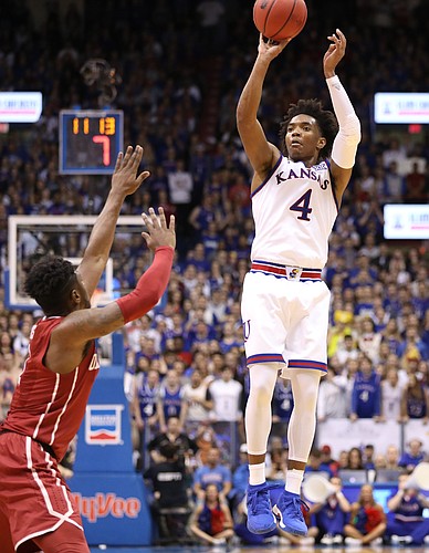 Kansas guard Devonte' Graham (4) pulls up for a three in front of Oklahoma guard Rashard Odomes (1) during the second half, Monday, Feb. 19, 2018 at Allen Fieldhouse.