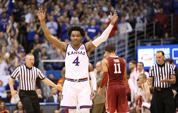 Kansas guard Devonte' Graham (4) raises up the Fieldhouse during a timeout in the second half, Monday, Feb. 19, 2018 at Allen Fieldhouse.