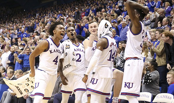 The Kansas bench celebrates a dunk in the final minutes by Kansas guard Sam Cunliffe (3) during the second half of their 104-74 win against Oklahoma on Monday, Feb. 19, 2018 at Allen Fieldhouse.