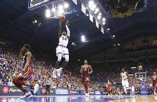 Kansas guard Malik Newman (14) soars in for a bucket during the second half, Monday, Feb. 19, 2018 at Allen Fieldhouse.