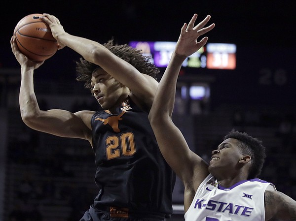 Texas forward Jericho Sims (20) pulls down a rebound against Kansas State forward James Love III, right, during the second half of an NCAA college basketball game in Manhattan, Kan., Wednesday, Feb. 21, 2018. Kansas State defeated Texas 58-48.