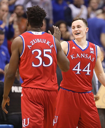 Kansas forward Mitch Lightfoot (44) celebrates with Kansas center Udoka Azubuike (35) during a timeout in the first half on Monday, Feb. 26, 2018 at Allen Fieldhouse.