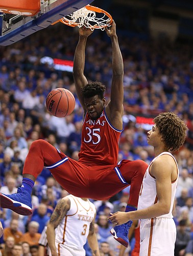Kansas center Udoka Azubuike (35) hammers in a dunk before Texas forward Jericho Sims (20) during the first half on Monday, Feb. 26, 2018 at Allen Fieldhouse.