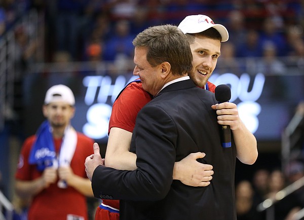 Kansas guard Sviatoslav Mykhailiuk gives a hug to Kansas head coach Bill Self before his senior speech.