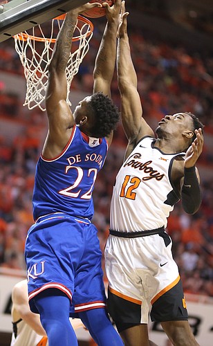 Kansas forward Silvio De Sousa (22) gets stuffed at the rim by Oklahoma State forward Cameron McGriff (12) during the second half, Saturday, March 3, 2018 at Gallagher-Iba Arena, in Stillwater, Okla.