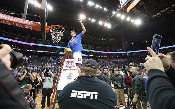 Kansas forward Mitch Lightfoot (44) holds up his piece of the net following the JayhawksÕ 81-70 win over the Mountaineers in the championship game of the Big 12 Tournament, Saturday, March 10, 2018 at Sprint Center in Kansas City, Mo.
