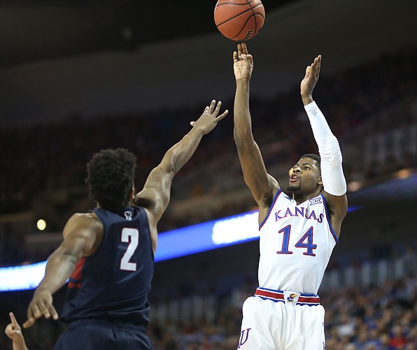 Kansas guard Malik Newman (14) puts up a three from the corner over Penn guard Antonio Woods (2) during the first half, Thursday, March 15, 2018 at Intrust Bank Arena in Wichita, Kan.