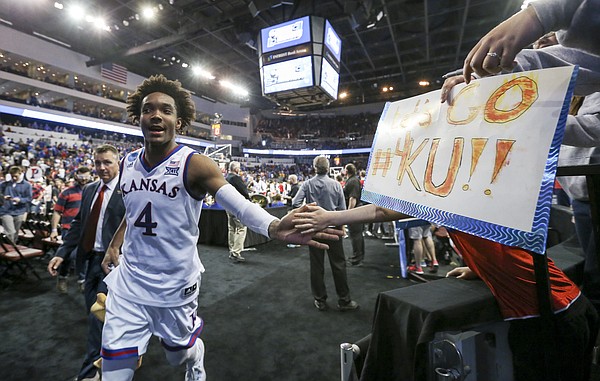 Kansas guard Devonte' Graham (4) slaps hands with fans as he leaves the court following the Jayhawks' first-round win over Penn, Thursday, March 15, 2018 at Intrust Bank Arena in Wichita, Kan.