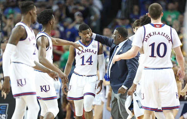 Kansas guard Malik Newman (14) gets a congratulatory pat on the head from assistant coach Jerrance Howard after a late three-pointer during the first half, Saturday, March 17, 2018 in Wichita, Kan.