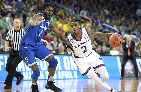Kansas guard Lagerald Vick (2) drives against Seton Hall forward Michael Nzei (1) during the second half, Saturday, March 17, 2018 in Wichita, Kan.