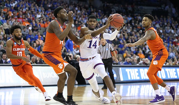 Kansas guard Malik Newman (14) heads in against the Clemson defense during the first half, Friday, March 23, 2018 at CenturyLink Center in Omaha, Neb.