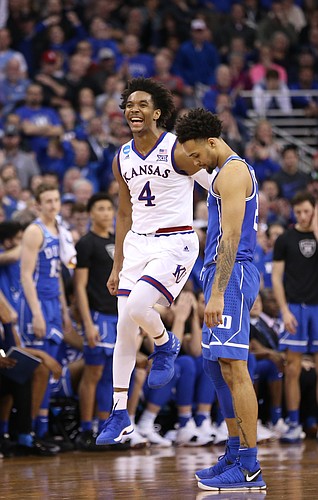 A giddy Kansas guard Devonte' Graham (4) jumps as the Jayhawks begin to secure the victory in overtime, Sunday, March 25, 2018 at CenturyLink Center in Omaha, Neb.
