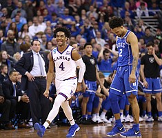 A giddy Kansas guard Devonte' Graham (4) jumps as the Jayhawks begin to secure the victory in overtime, Sunday, March 25, 2018 at CenturyLink Center in Omaha, Neb.