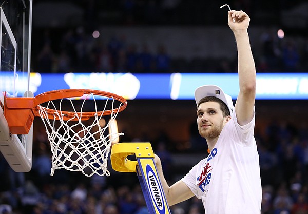 Kansas guard Sviatoslav Mykhailiuk (10) holds up his share of the net as the Jayhawks celebrate a trip to the Final Four following their 85-81 overtime victory over Duke on Sunday in Omaha, Neb.
