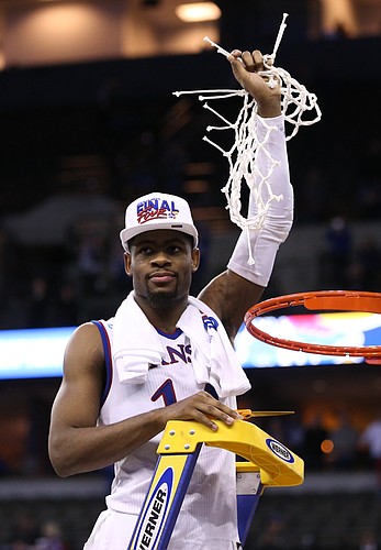 Kansas guard Malik Newman (14), the MVP for the Midwest Regional, hoists the remainder of the net as the Jayhawks celebrate a trip to the Final Four following their 85-81 overtime victory over Duke on Sunday in Omaha, Neb.