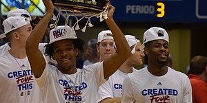 Senior guard Devonte' Graham hoists an Elite Eight victory trophy above his head at Allen Fieldhouse after the Jayhawk's 85-81 victory over Duke in Omaha, Neb. earlier in the day on Sunday, March 25, 2018. KU will face Villanova in the Final Four round of the NCAA tournament in San Antonio, Texas on Saturday.