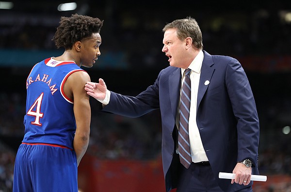 Kansas head coach Bill Self and Kansas guard Devonte' Graham (4) have a talk on the sidelines during a break in action in the second half, Saturday, March 31, 2018 at the Alamodome in San Antonio, Texas.