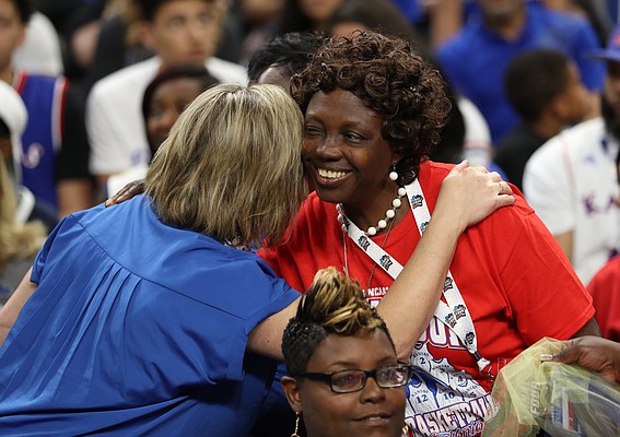 Florence Azuonuwu, mother of Kansas center Udoka Azubuike gets a welcoming hug from a KU fan prior to tipoff on Saturday, March 31, 2018 at the Alamodome in San Antonio. Azuonuwu traveled from Delta, Nigeria to see her son play, whom she hasn't seen in six years.