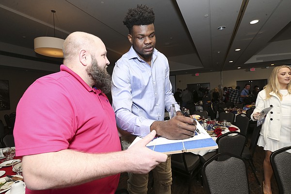 Kansas center Udoka Azubuike signs an autograph for a fan following the Kansas basketball banquet on Tuesday, April 10, 2018 at the DoubleTree Hotel in Lawrence.