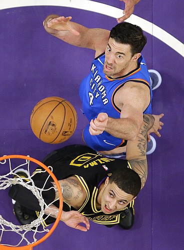 Los Angeles Lakers forward Kyle Kuzma, below, and Oklahoma City Thunder forward Nick Collison wait for a rebound during the second half of an NBA basketball game Thursday, Feb. 8, 2018, in Los Angeles. The Lakers won 106-81. (AP Photo/Mark J. Terrill)