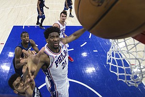 Philadelphia 76ers' Joel Embiid, right, of Cameroon, blocks out Minnesota Timberwolves' Karl-Anthony Towns, left, from the rebound during the first half of an NBA basketball game, Saturday, March 24, 2018, in Philadelphia. The 76ers won 120-108. (AP Photo/Chris Szagola)