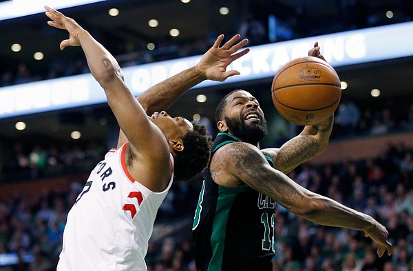 Boston Celtics' Marcus Morris (13) blocks a shot by Toronto Raptors' Kyle Lowry during the fourth quarter of an NBA basketball game in Boston, Saturday, March 31, 2018. The Celtics won 110-99. (AP Photo/Michael Dwyer)
