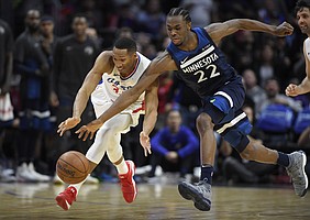 Los Angeles Clippers forward Wesley Johnson, left, and Minnesota Timberwolves forward Andrew Wiggins go after a loose ball during the second half of an NBA basketball game, Monday, Jan. 22, 2018, in Los Angeles. The Timberwolves won 126-118. (AP Photo/Mark J. Terrill)