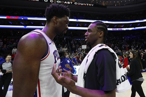 Minnesota Timberwolves' Andrew Wiggins, right, talks things over with Philadelphia 76ers' Joel Embiid, of Cameroon, following the second half of an NBA basketball game, Saturday, March 24, 2018, in Philadelphia. The 76ers won 120-108. (AP Photo/Chris Szagola)