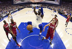 In this photo taken with a fisheye lens, Philadelphia 76ers' Joel Embiid, of Cameroon, dunks the ball during the first half in Game 5 of a first-round NBA basketball playoff series against the Miami Heat, Tuesday, April 24, 2018, in Philadelphia. The 76ers won 104-91. (AP Photo/Chris Szagola)