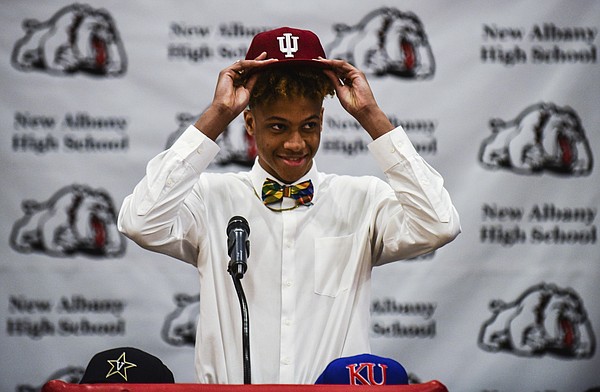 Romeo Langford places an Indiana University cap onto his head after selecting to continue his basketball career with the Hoosiers on Monday at New Albany High School, Monday, April 30, 2018, in New Albany, Ind. 
