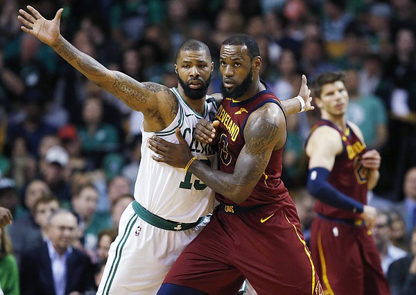 Cleveland Cavaliers forward LeBron James, right, fights for position against Boston Celtics forward Marcus Morris (13) during the third quarter of Game 1 of the NBA basketball Eastern Conference Finals, Sunday, May 13, 2018, in Boston. (AP Photo/Michael Dwyer)
