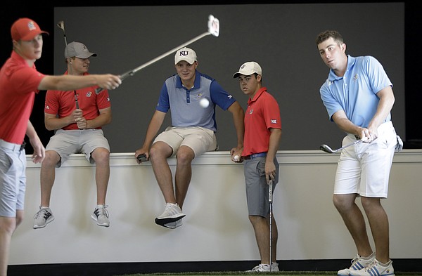 KU senior golfer Daniel Hudson, right, takes some chip shots inside the new KU Golf facility at the Jayhawk Club. Pictured from left are team members Harry Hillier, his brother Charlie Hillier, Andy Spencer, Ben Sigel and Hudson. 