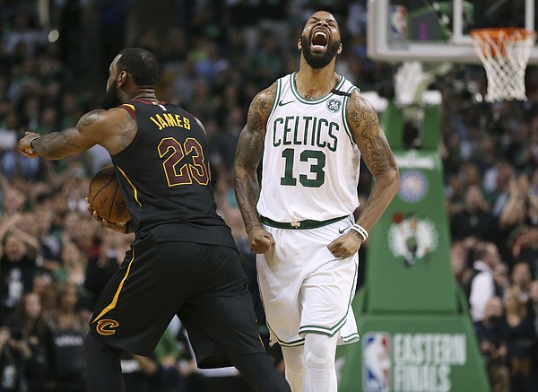 Boston Celtics forward Marcus Morris, right, and Cleveland Cavaliers forward LeBron James react after James didn't cross the half court line in the allotted time during the second half in Game 7 of the NBA basketball Eastern Conference finals, Sunday, May 27, 2018, in Boston. (AP Photo/Elise Amendola)